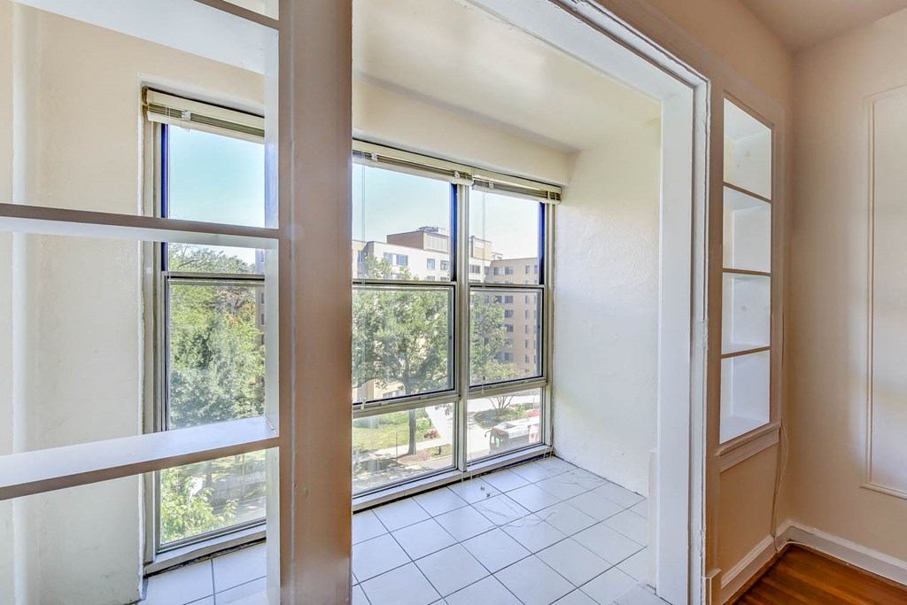 vacant sunroom with large windows and tile flooring at the frontenac apartments in van ness washington dc