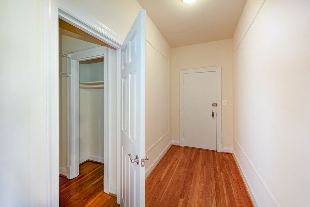 hallway view of front entrance with hardwood floors at the frontenac apartments in van ness washington dc