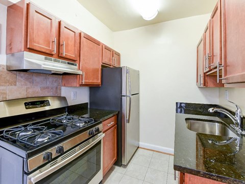 a kitchen with a stove refrigerator and sink