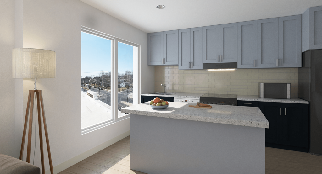kitchen with large windows and kitchen island at the strand apartments in hillbrook deanwood washington dc
