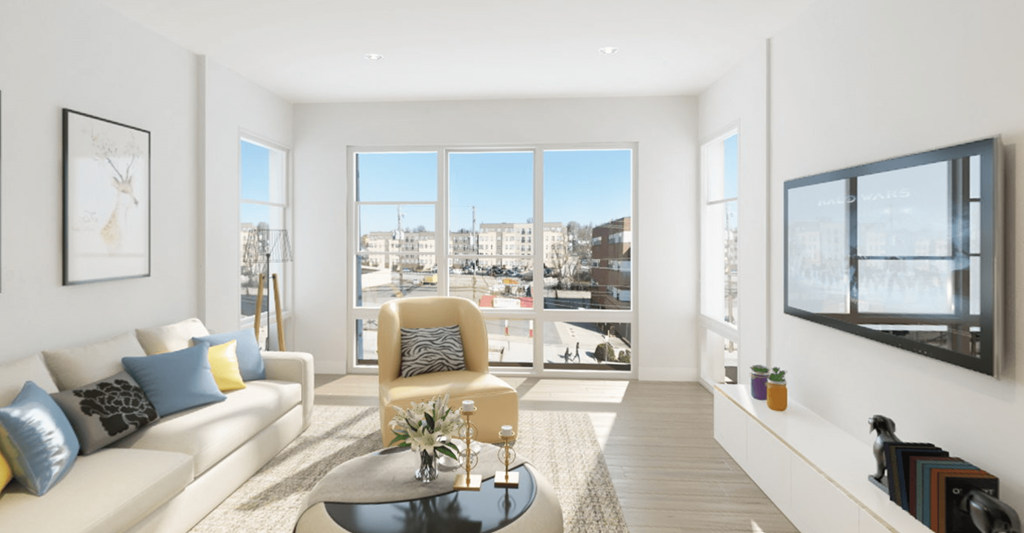 living room with floor to ceiling windows and wood flooring at the strand apartments in hillbrook deanwood washington dc