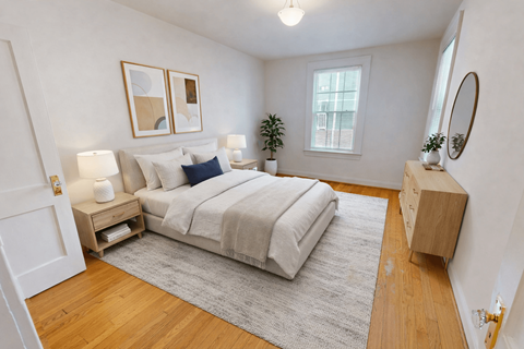 A bedroom with a bed, nightstands, and a rug.