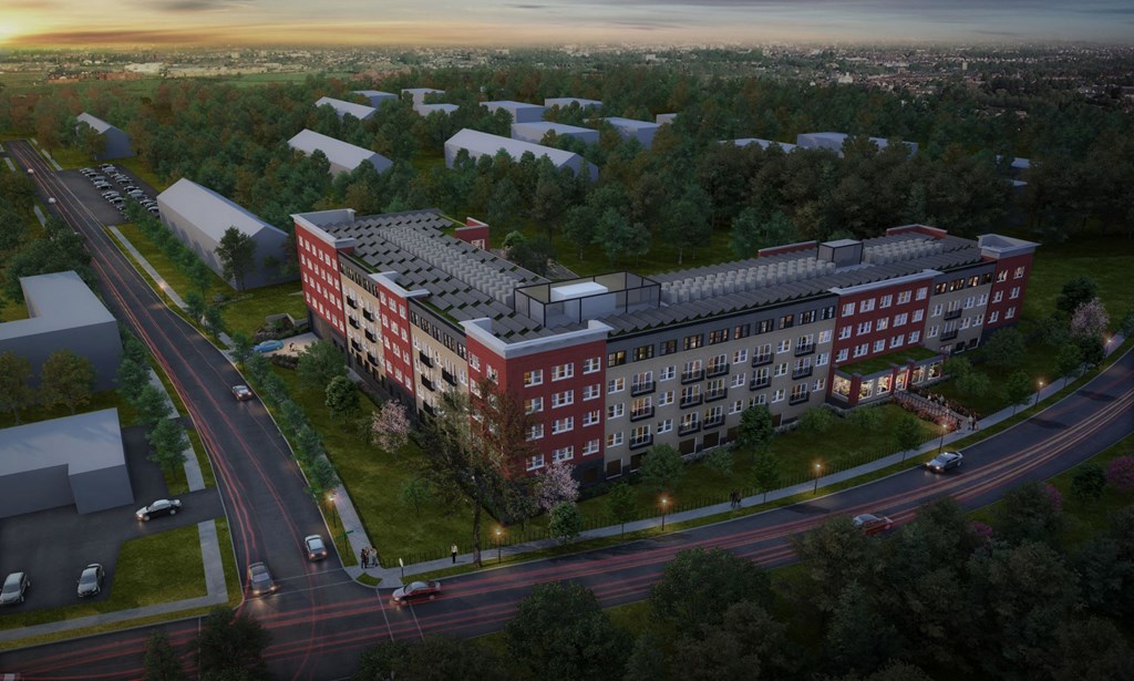 an aerial view of a large apartment building with a parking lot in front of it