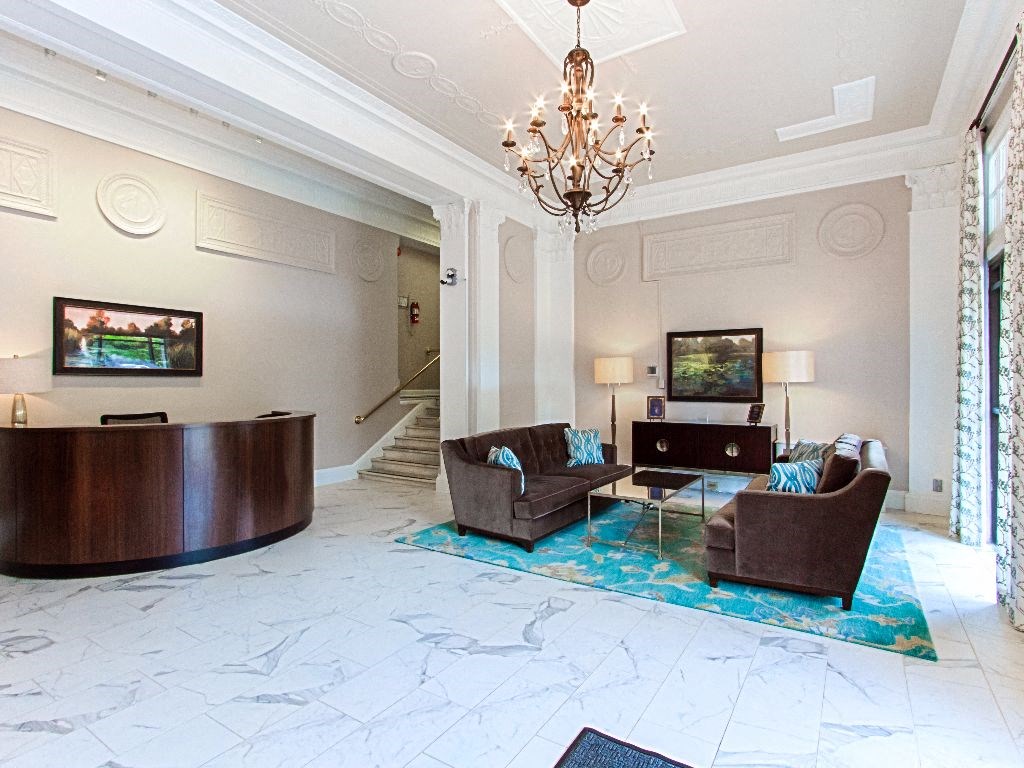 a lobby with couches, a table and a chandelier at the calverton apartment building in adams morgan washington dc