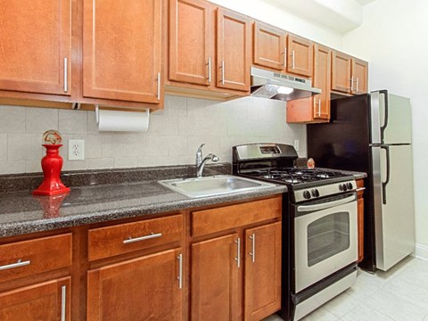a kitchen with stainless steel appliances and wooden cabinets