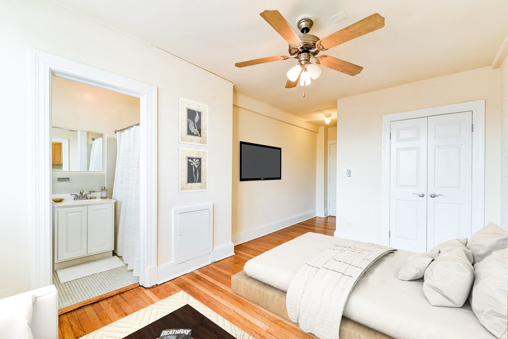 bedroom with bed, view of bathroom ceiling fan and hardwood floors at the foreland apartments in washinton dc