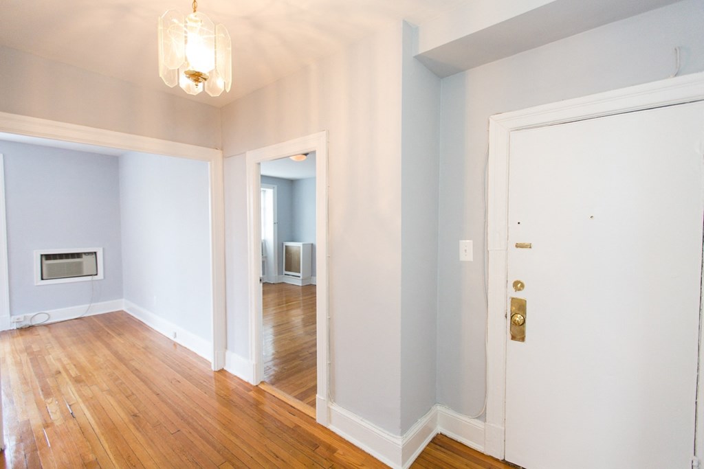 foyer of apartment with modern lighting and hardwood flooring at the shawmut apartments in adams morgan washington dc