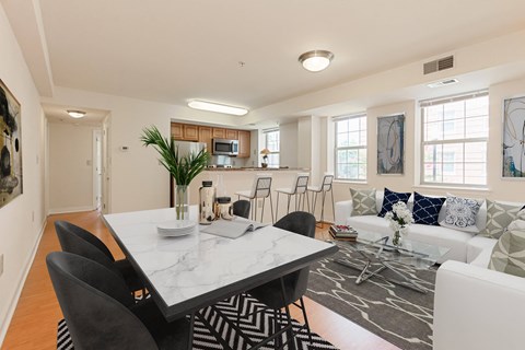 a living room with a dining room table and a kitchen