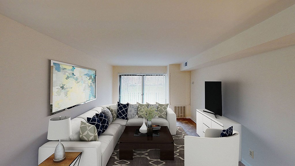 living area with sofa, coffee table, credenza, tv and large windows at washington view apartments in southeast dc