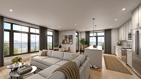A modern living room with a large grey sofa and a coffee table.