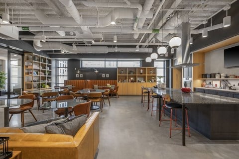 a restaurant with a bar and tables and chairs and a kitchen