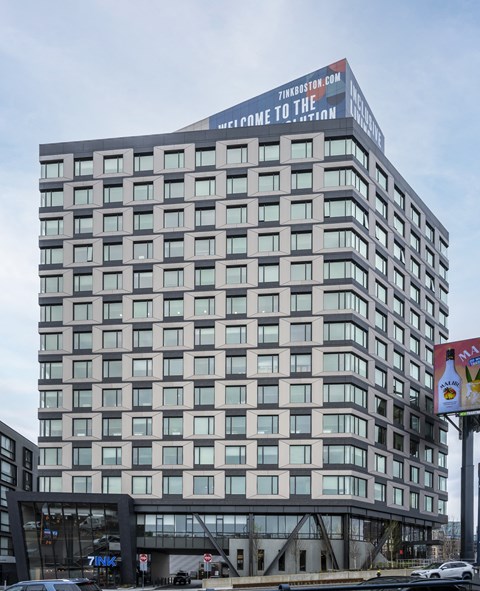 a tall building with a sign on the top of it
