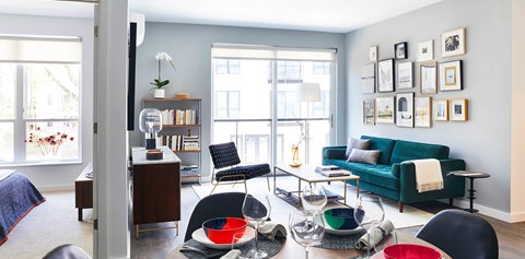 A living room with a green couch and a coffee table with bowls on it.