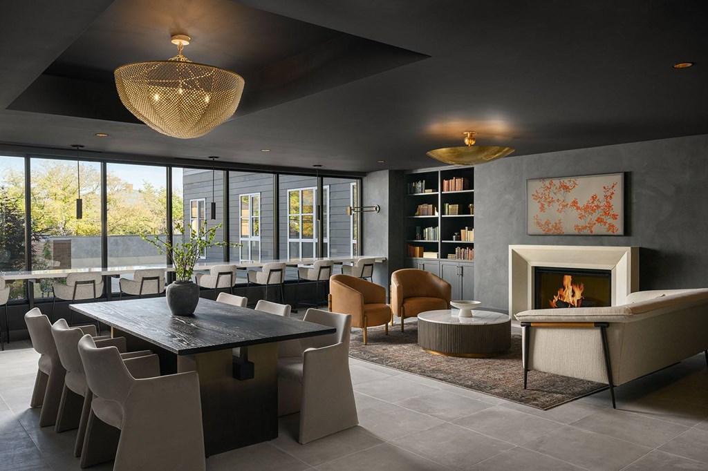 A modern dining room with a fireplace and a large table.