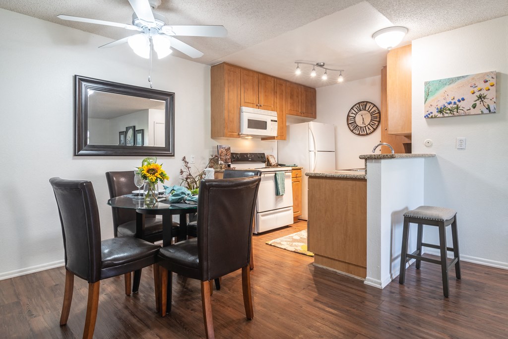 a kitchen and dining room with a table and chairs