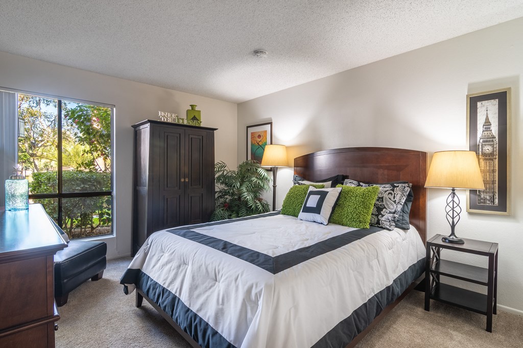 the master bedroom has a large bed and a large window