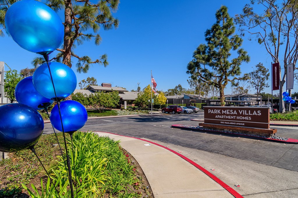 A sign for Park Mesa Villas Apartment Homes is in front of a building.