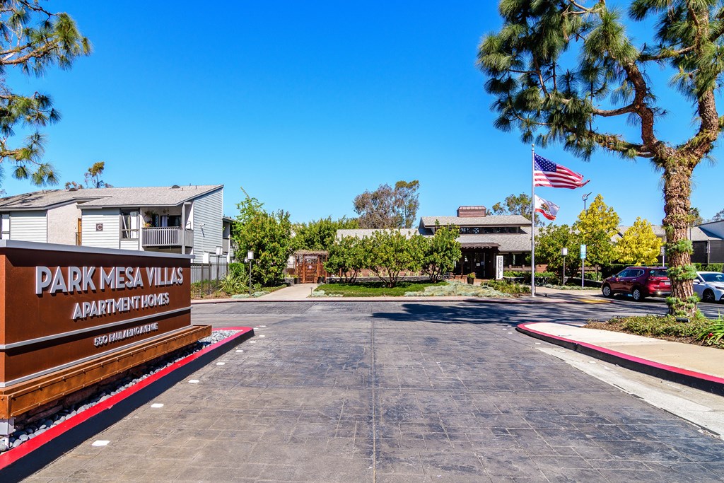 A sign for Park Mesa Villas Apartment Homes is in front of a building.