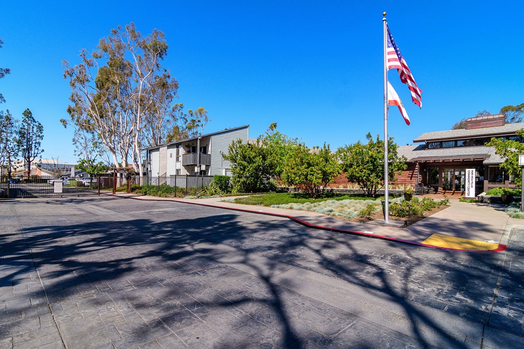 A parking lot with a flag pole in the middle.