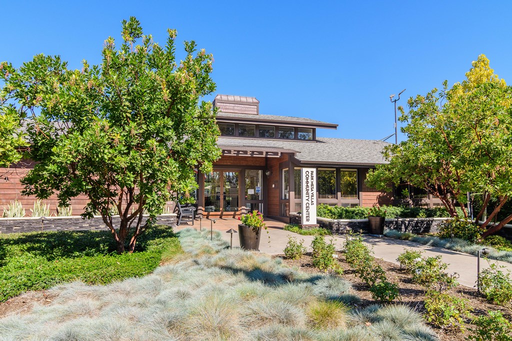 A building with a brown roof and a sign that says "CONSERVATORY" in front of it.