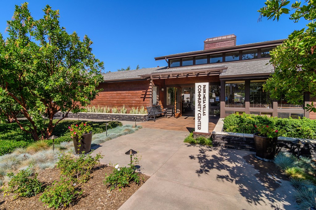 A building with a sign that says "Community Center" is surrounded by greenery.