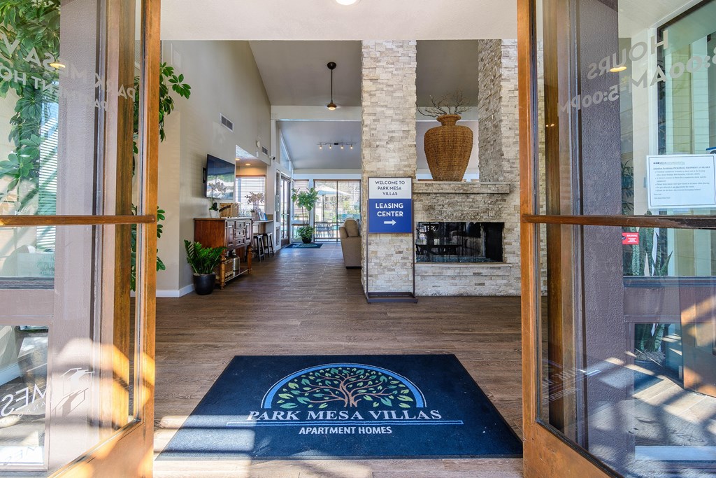 The image shows the entrance to Park Mesa Villas Apartment Homes with a blue doormat and a sign.