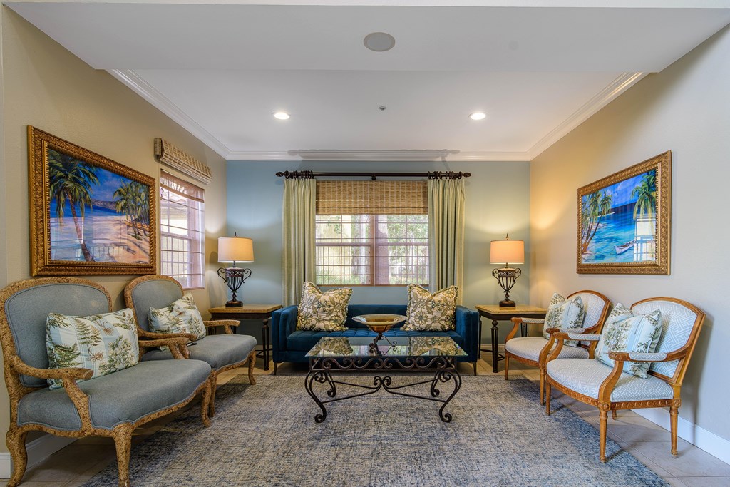 A living room with a blue couch and two chairs.