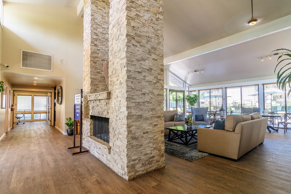 A living room with a stone fireplace and a couch.