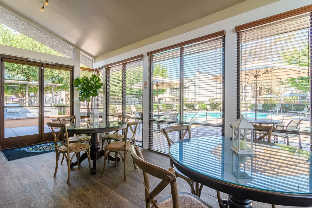 A dining room with a glass table and chairs.