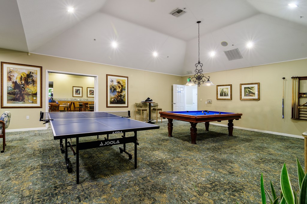 A room with a pool table and a ping pong table.