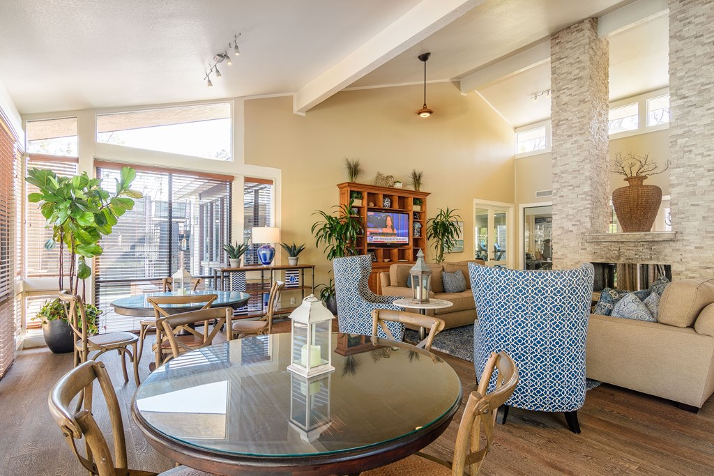 A living room with a glass table and chairs.