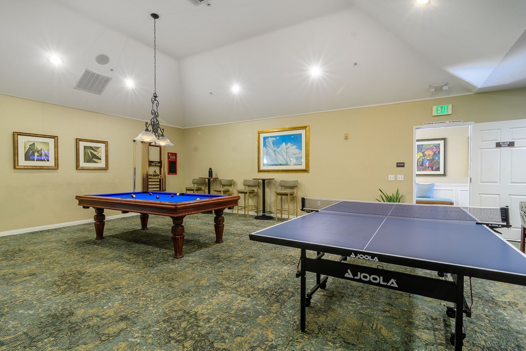 A room with a JOOLA table tennis table and a pool table.