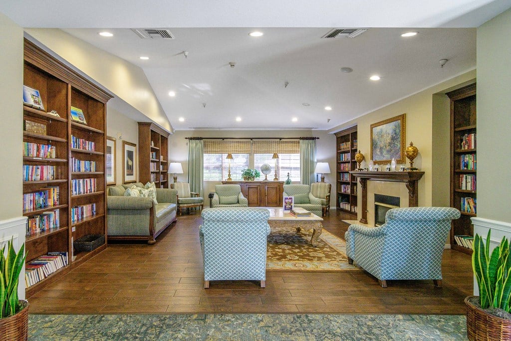 A living room with a fireplace and a bookshelf.