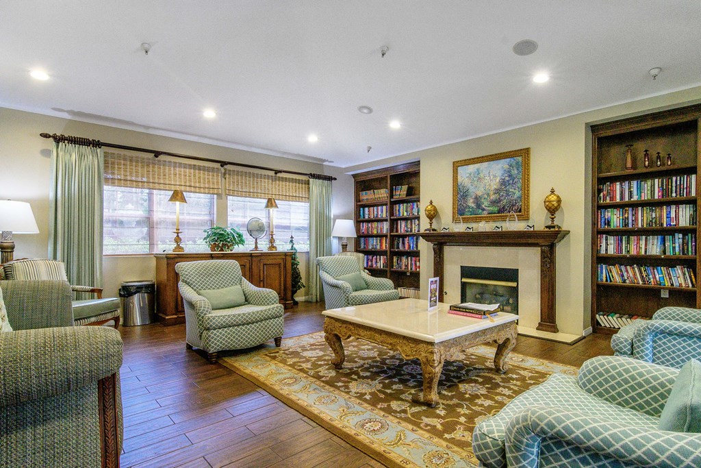 A living room with a fireplace and a bookshelf.
