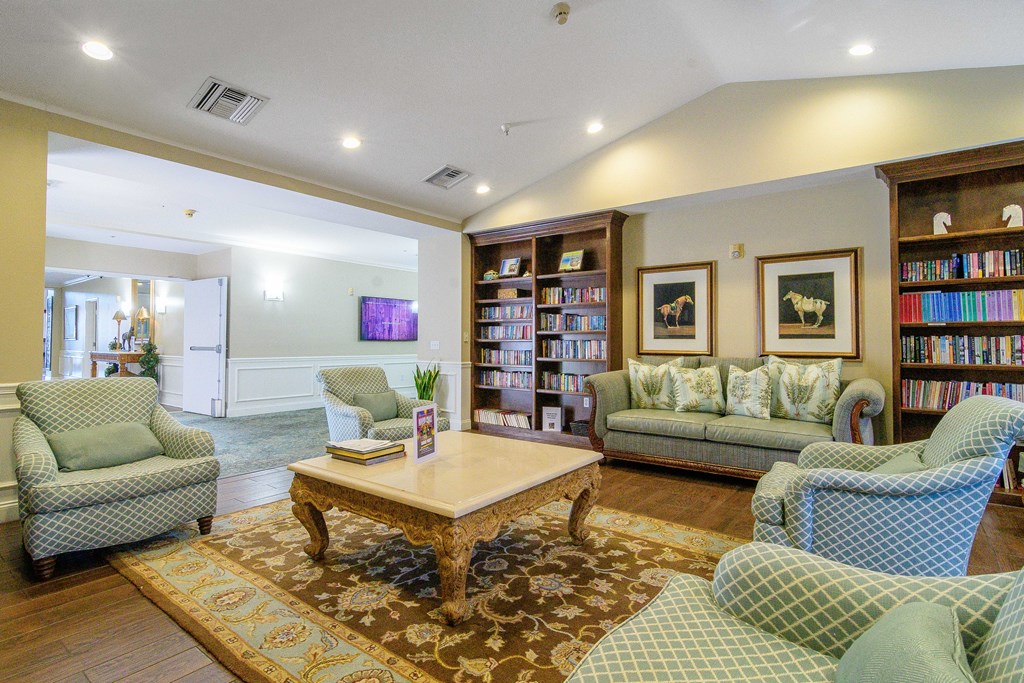 A living room with a sofa, armchair, and coffee table.