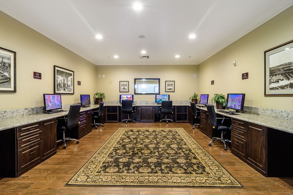 A room with a carpet and multiple computer screens.