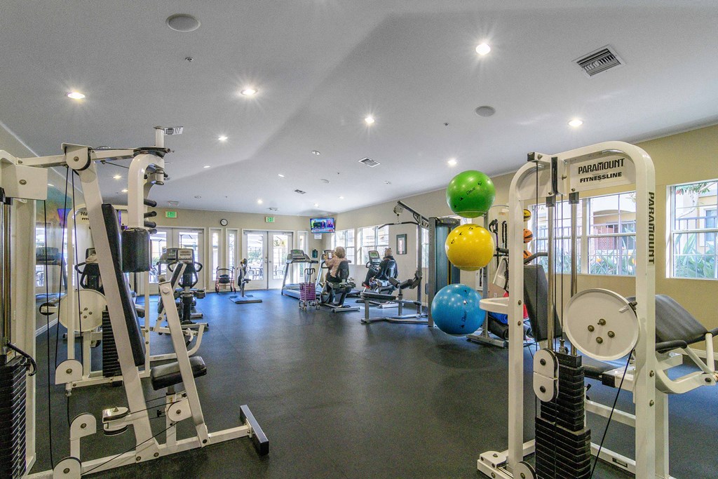 A gym with a variety of equipment including a leg press machine.