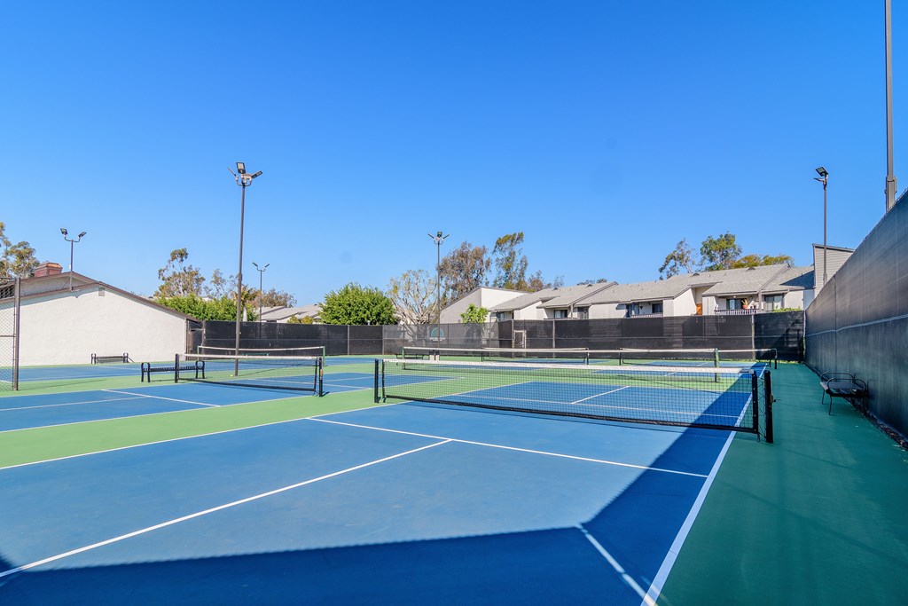 A tennis court with a blue surface and white lines.