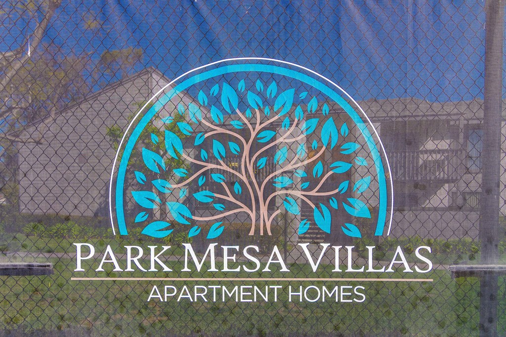 A sign for Park Mesa Villas Apartment Homes with a tree logo.