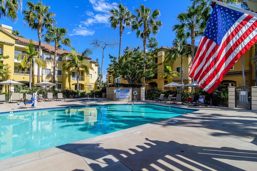 A pool area with a large American flag.