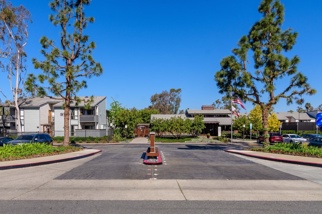 A street view of a residential area with a clear blue sky.