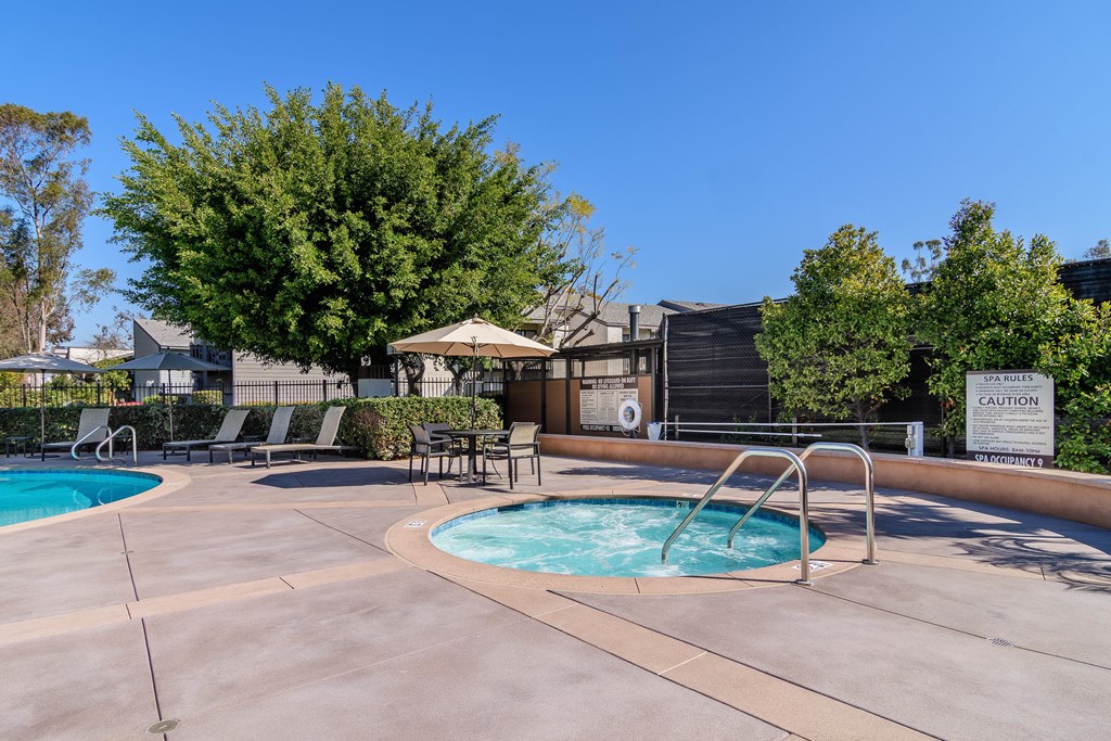 A pool with a caution sign in the background.