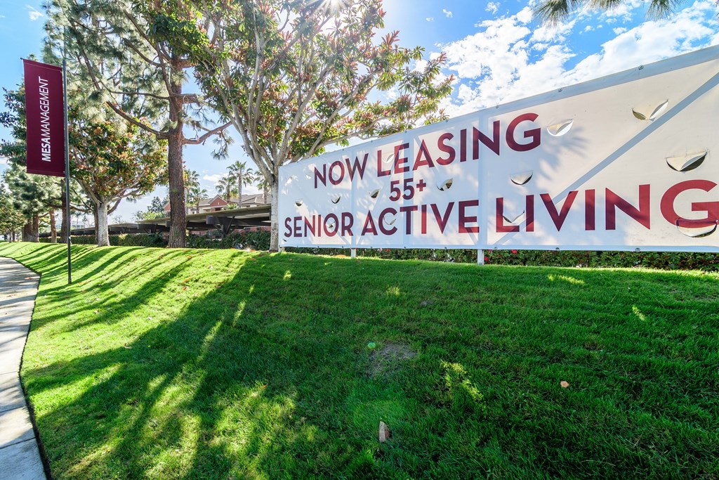 A sign for Senior Active Living is displayed in front of a building.