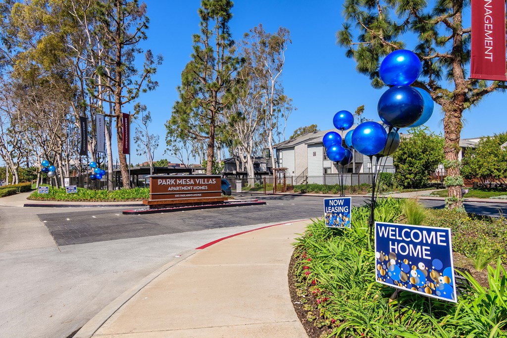 A sign that says "Welcome Home" is in front of a building.