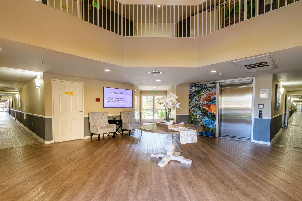 A room with a wooden floor and a wall mural with a glass door.
