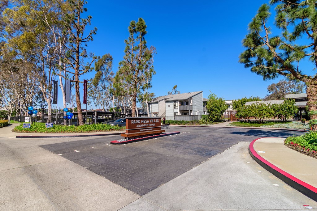 A sign that says "Dark Mesa Village" is in front of a building.
