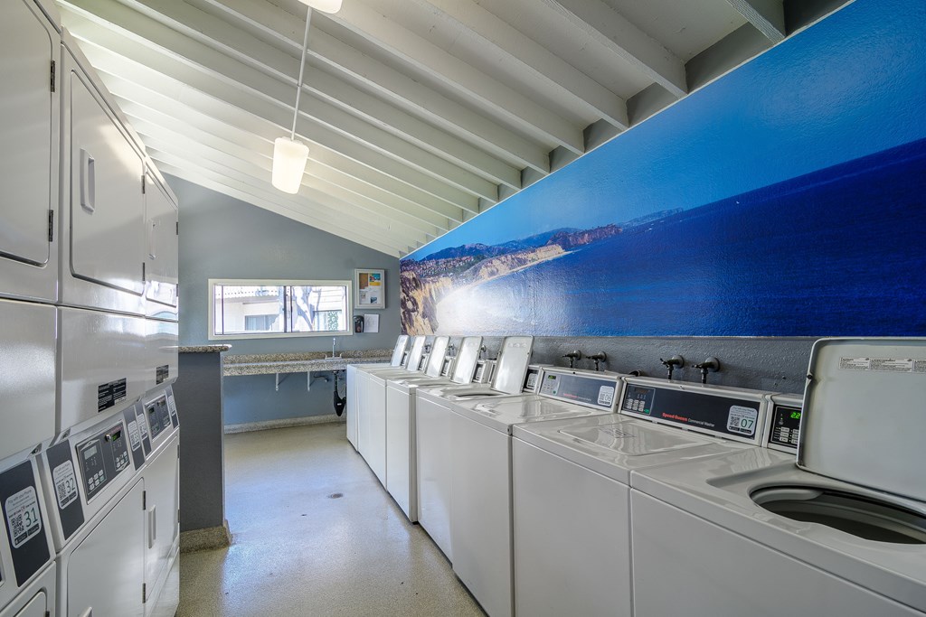 A row of washing machines in a laundromat.