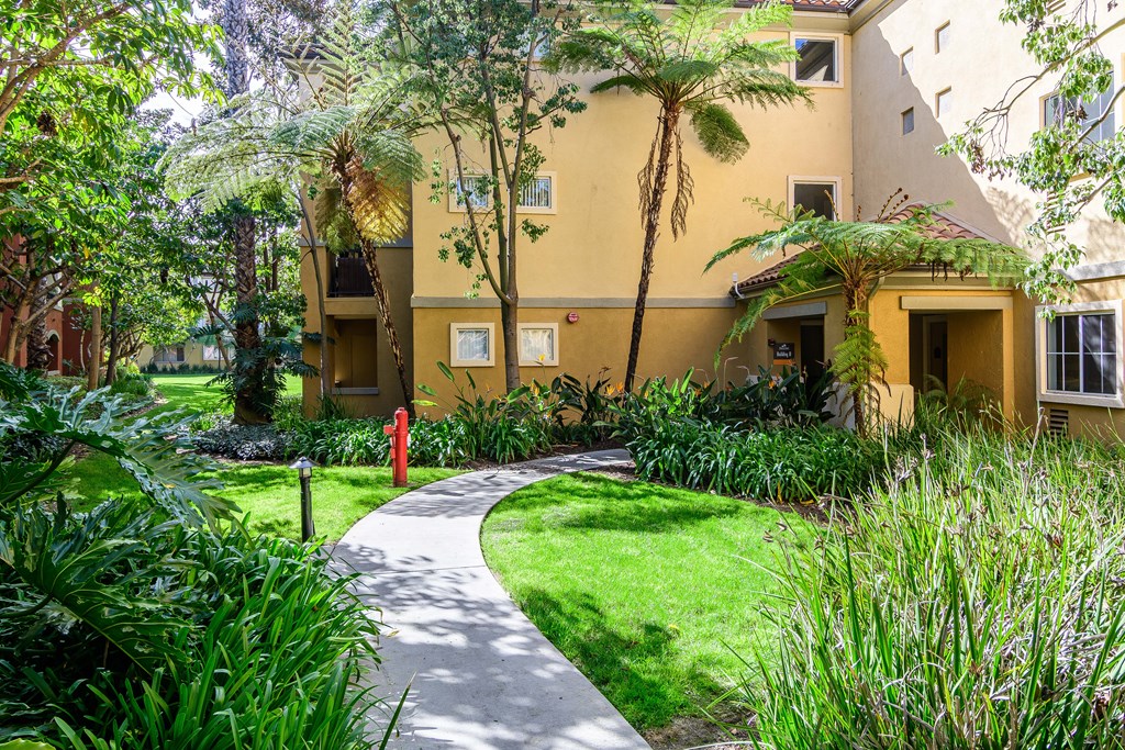 A yellow building with a red fire hydrant in front of it.