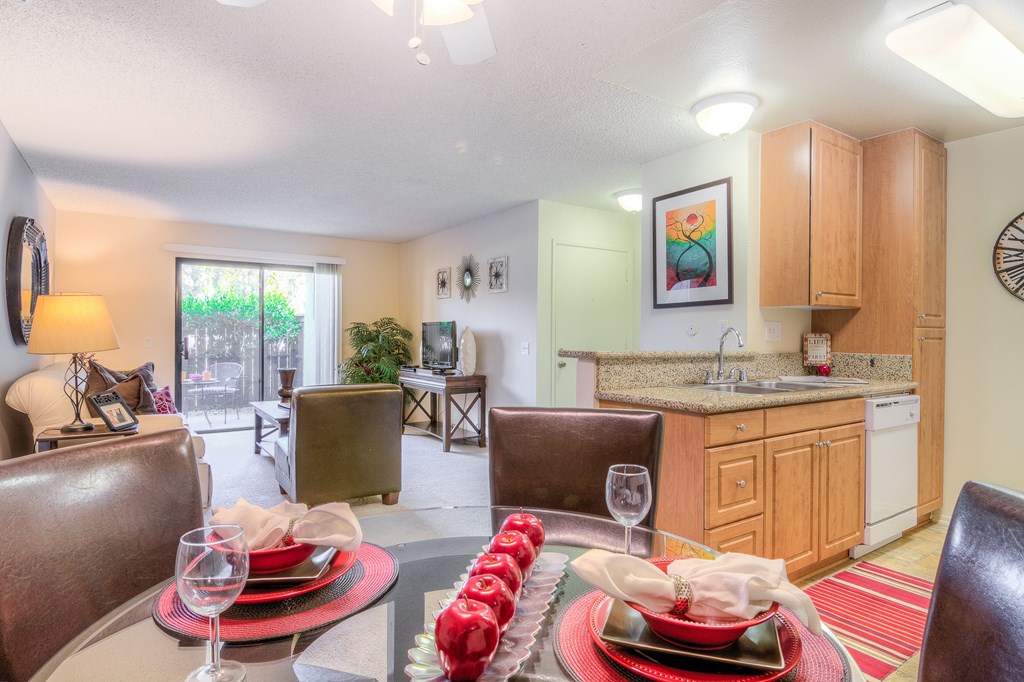 A dining room with a table set for a meal.