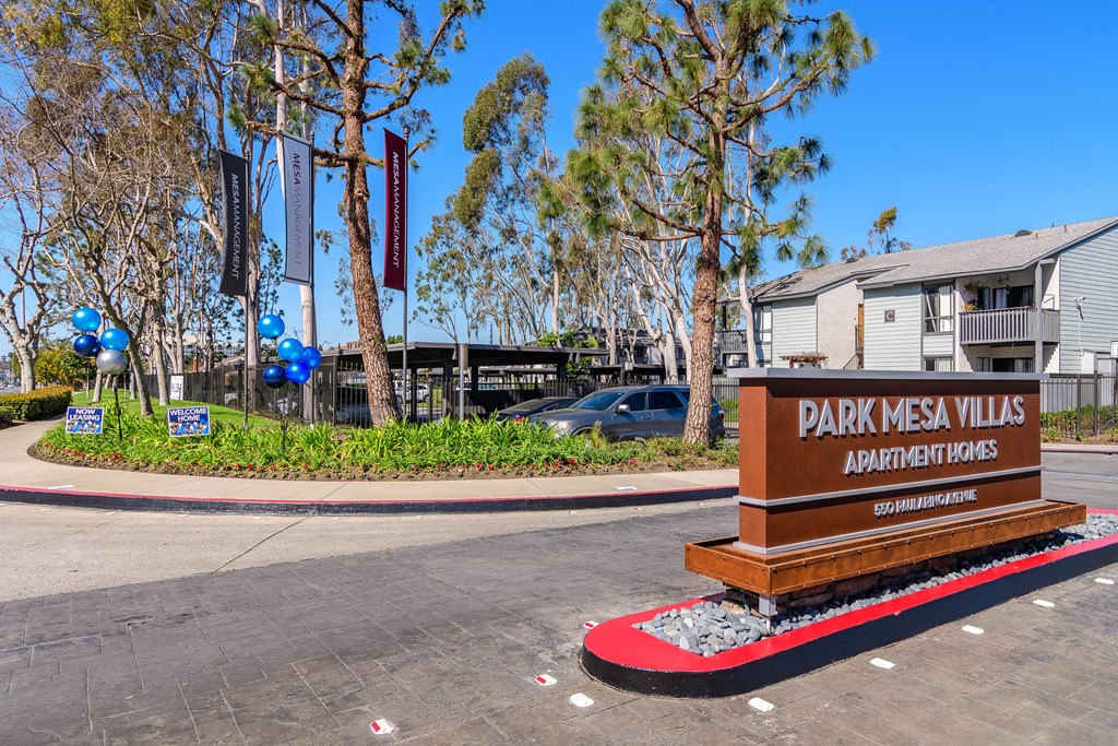 A sign for Park Mesa Villas Apartment Homes is in front of a building.